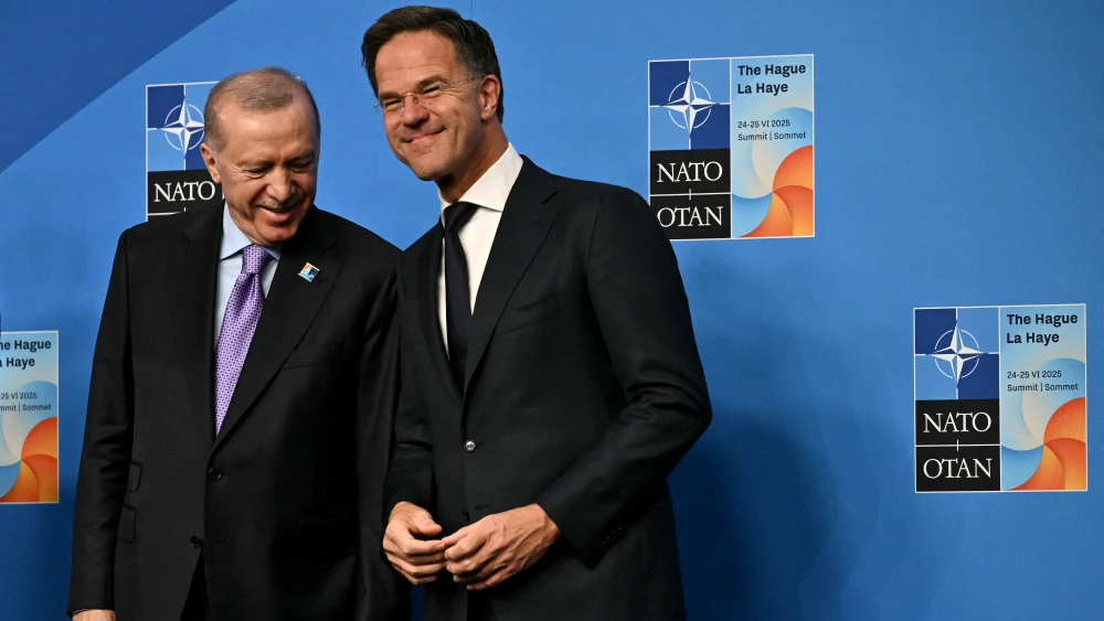 Turkish Presidnt Recep Tayyip Erdoğan poses for a picture with NATO Secretary-General Mark Rutte at a NATO summit in The Hague, June 25, 2025. Photo by Ben Stansall/AFP via Getty Images.