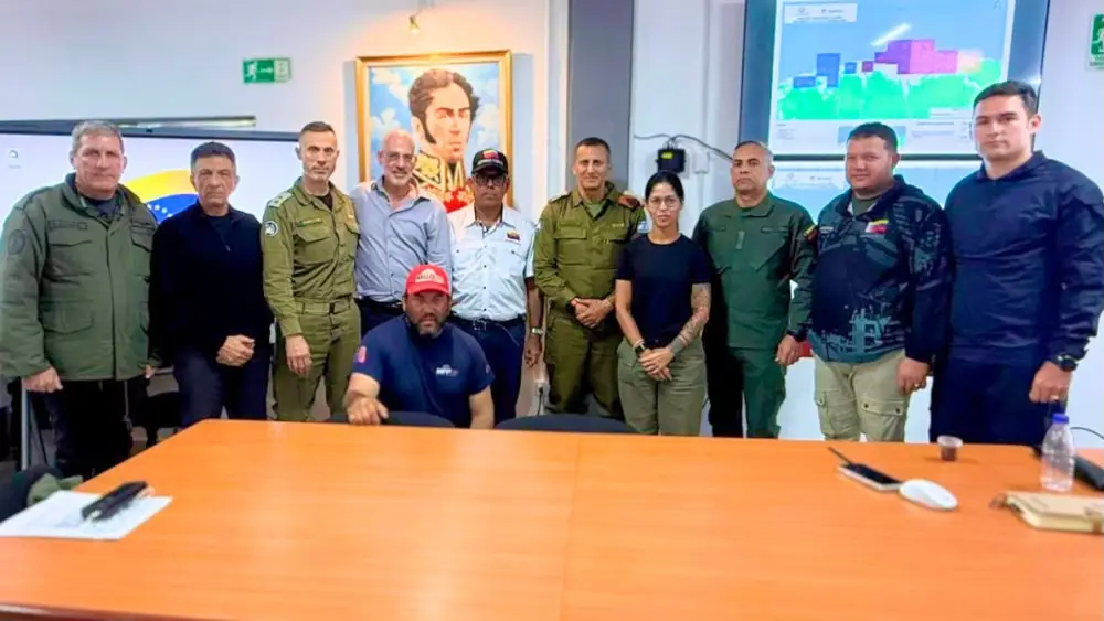 Israeli and Venezuelan officials pose for a group photo during a July 2, 2026, meeting at an operations center supporting a structural assessment mission in Venezuela, where participants discussed aligning local assessment methods with Israeli practices. Credit: IDF.