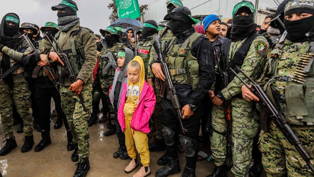 Members of the Al-Qassam Brigades hand over Israeli hostages to the Red Cross, as part of the ceasefire agreement between Israel and Hamas, in Rafah, Feb. 22, 2025. Photo by Abed Rahim Khatib/Flash90.