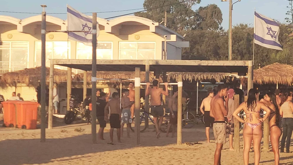 Beachgoers soak up the last rays of sunlight at Moshav Shavei Tzion in the Western Galilee on June 24, 2025. Photo by Canaan Lidor.