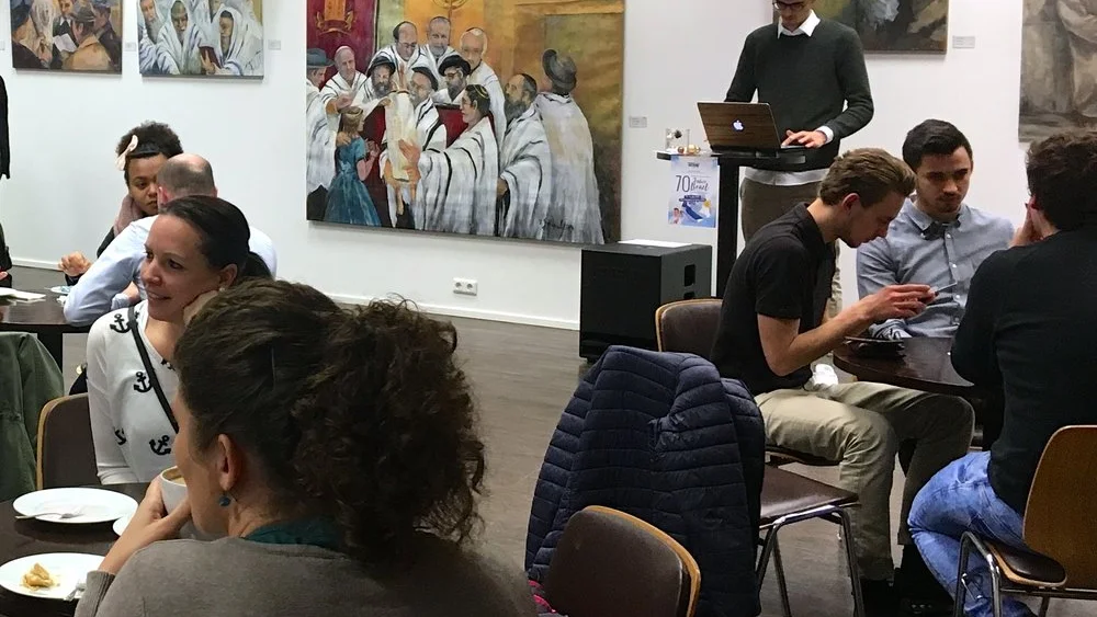 The walls in the lobby of Tübingen’s TOS Ministries are adorned with paintings of rabbis and Jewish children. Credit: Orit Arfa.