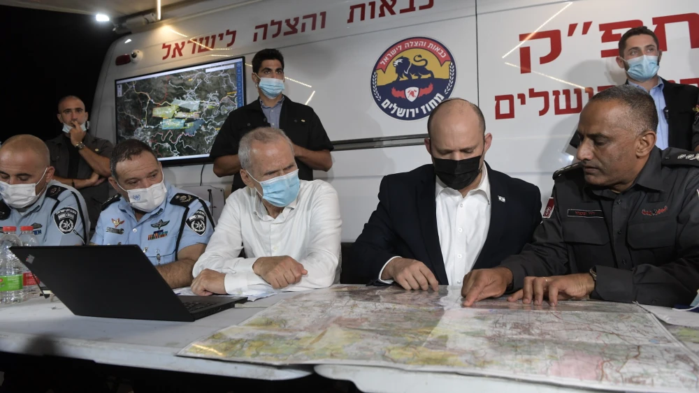 Israeli Prime Minister Naftali Bennett at a command-and-control center set up in Jerusalem to strategize over managing wildfires in Jerusalem and its environs, Aug. 15, 2021. Credit: GPO/Kobi Gideon.