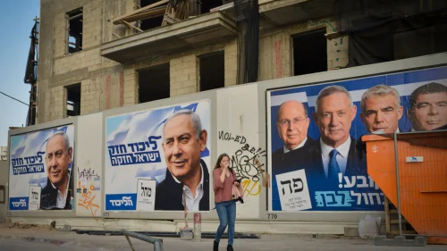 Election campaign posters in Tel Aviv depict Israeli Prime Minister Benjamin Netanyahu, head of the Likud Party, as well as the leaders of the Blue and White Party, including Benny Gantz, second from left, Sept. 2019. Photo by Adam Shuldman/Flash90.