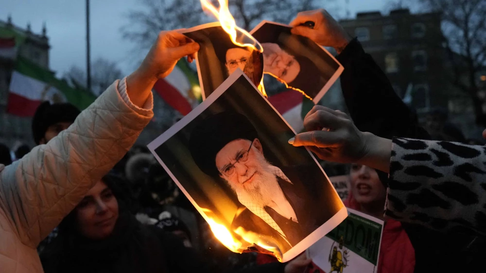 Protestors burn images of Ayatollah Ali Khamenei during a rally held in solidarity with Iran's uprising, organized by the National Council of Resistance of Iran, on Whitehall in central London on Jan. 11, 2026. Photo by Carlos Jasso / AFP via Getty Images.