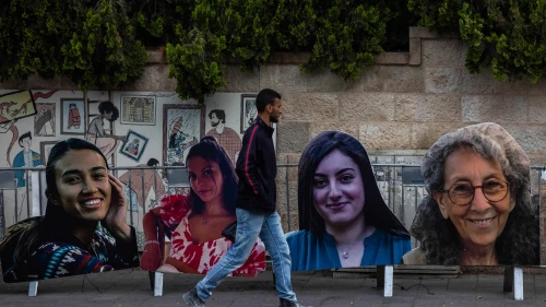 People walking next to large pictures of Israeli women held hostage in the Gaza Strip as part of a protest calling for their release, near the Prime Minister's official residence in Jerusalem, May 2, 2024. Photo by Yonatan Sindel/Flash90.