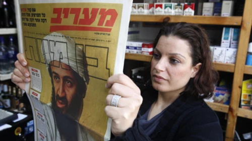 Israelis read about the death of Al-Qaeda leader Osama bin Laden in the news on May 3, 2011. Photo by Miriam Alster/Flash90