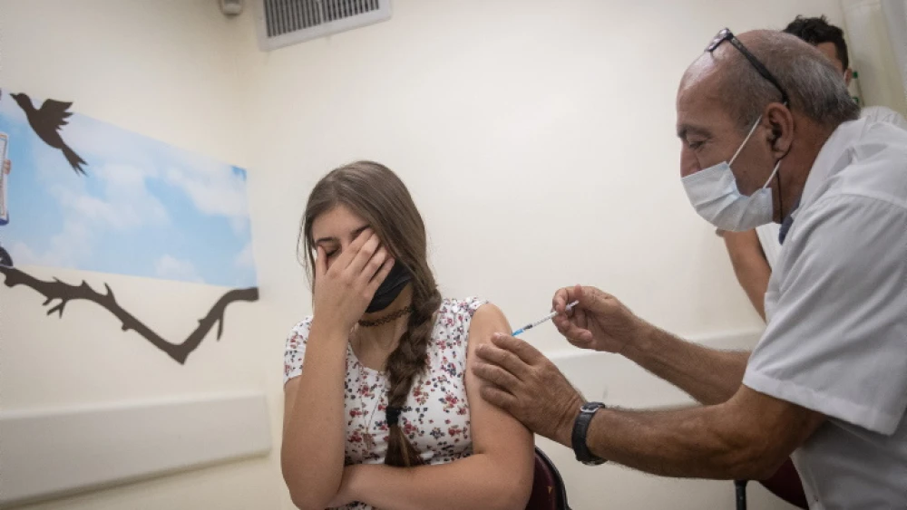 An Israeli girl receives a COVID-19 vaccine in Jerusalem, June 24, 2021. Photo by Yonatan Sindel/Flash90.