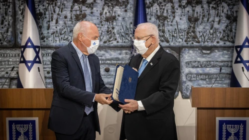 Israeli President Reuven Rivlin receives the official election results from the head of the Israeli electoral committee, judge Uzi Vogelman, during a ceremony at the President's Residence in Jerusalem on March 31, 2021. Photo by Yonatan Sindel/Flash90.