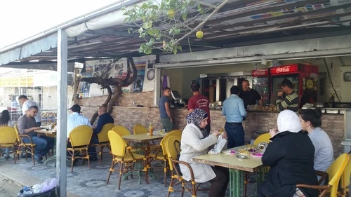 Israeli Jews and Palestinian Arabs eat lunch at a falafel joint in an Arab strip mall in Ariel Credit: Orit Arfa.