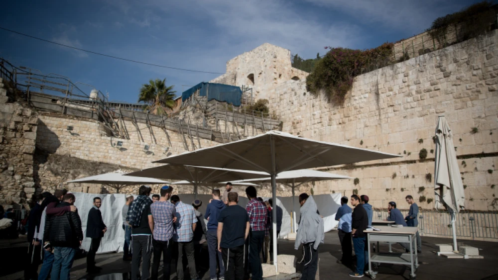 Jews pray at the mixed-gender prayer section at the Western Wall in Jerusalem Old City on Jan. 3, 2018, ahead of a hearing at Israel's Supreme Court regarding the Western Wall layout. Photo by Yonatan Sindel/Flash90.