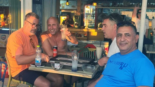 Ron Hazan raises a glass with friends at Moshav Shavei Tzion in the Western Galilee on June 24, 2025. Photo by Canaan Lidor.