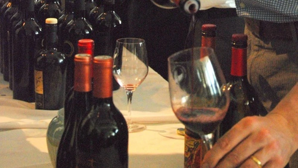 A fine wine—one of several hundred—sampled at the 2012 Kosher Food and Wine Experience. Vintners from around the globe introduced a wide range of kosher wines to discerning palates at the one day extravaganza. Here, Covenant associate winemaker Jonathon Hajdu pours an extraordinary red produced by the Northern California kosher winery. Credit: Maxine Dovere.