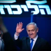 Israeli Prime Minister Benjamin Netanyahu waves to supporters on the night of the Israeli elections at Likud Party headquarters in Tel Aviv, March 2, 2020. Photo by Olivier Fitoussi/Flash90.