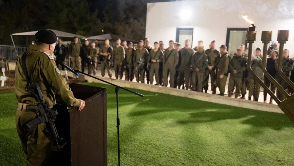 Israel Defense Forces Chief of Staff Lt. Gen. Eyal Zamir lights the first Chanukah candle with troops of the 91st Division, Dec. 14, 2025. Credit: IDF.