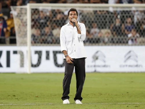 French-Israeli singer Laurent Amir Haddad, also known as Amir, performs before the start of the French Champions' Trophy final soccer match between Paris Saint-Germain and Lille at Bloomfield Stadium in Jaffa, on Aug. 1, 2021. Photo by Emmanuel Dunand/AFP via Getty Images.