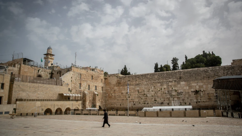 A Jewish man walks at the almost empty Western Wall, in the Old City of Jerusalem, March 27, 2020. Photo by Yonatan Sindel/Flash90.