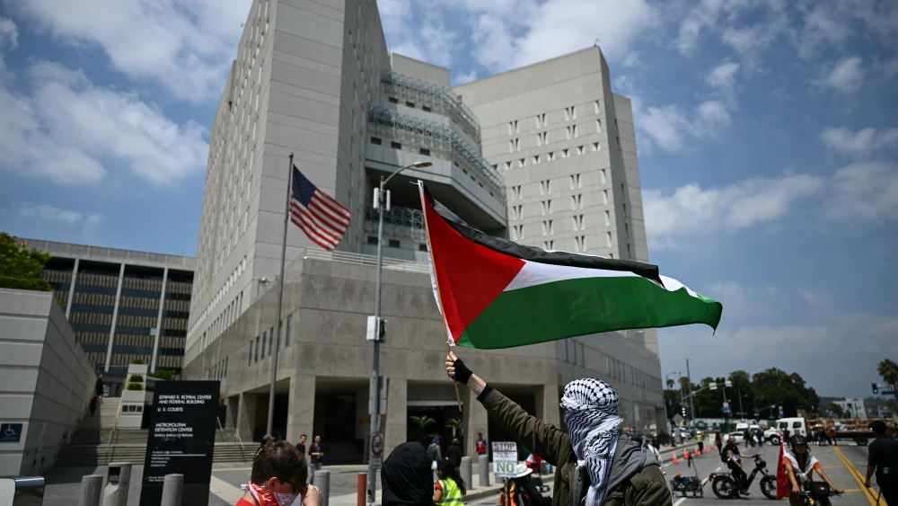 A pro-Palestinian protestor waves a Palestinian flag during a May Day Workers Unite! march in Los Angeles, California, on May 1, 2025. Photo by Patrick T. Fallon/AFP via Getty Images.