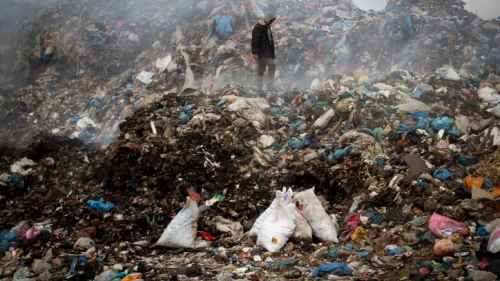 Palestinian men collect recycling materials from the Gaza Strip's main garbage dump in Rafah, near the border with Israel, on April 16, 2015. Photo by Abed Rahim Khatib/Flash 90.