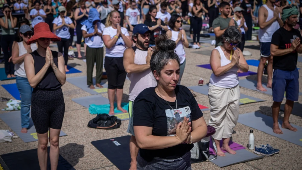 People practicing yoga at "Hostage Square" in Tel Aviv to mark the 40th birthday of Israeli captive in Gaza Carmel Gat, May 17, 2024. Photo by Avshalom Sassoni/Flash90.