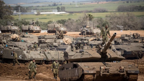 Israeli soldiers seen near IDF tanks stationed near the Israeli Gaza border on March 26, 2019. Credit: Yonatan Sindel/Flash90