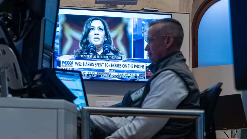 Traders work on the floor of the New York Stock Exchange as a picture of Vice President Kamala Harris is displayed on a television screen on July 22, 2024. Credit: Spencer Platt / Getty Images.