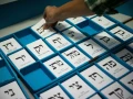 Ballot slips for competing parties are seen at a polling station in Jerusalem as Israelis vote in the March 23, 2021, election. Credit: Yonatan Sindel/Flash90.