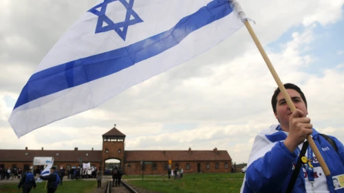 A young Israeli woman waves the Israeli flag as she participates with hundreds of other Israeli youth in the “March of the Living” annual program in Poland, on May 2, 2011. Photo by Yossi Zeliger/Flash90.