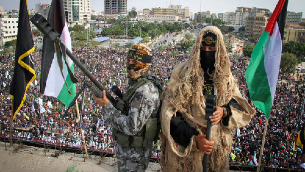 Palestinian Islamic Jihad terrorists stand guard on a roof in Gaza City during a rally marking the 29th anniversary of the terror group’s founding, Oct. 21, 2016. Credit: Abed Rahim Khatib/Flash90.