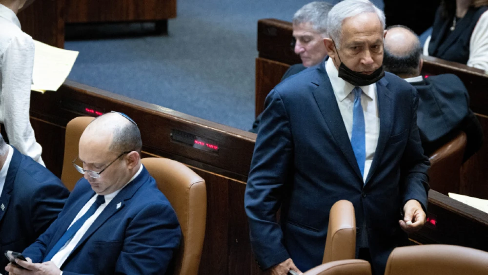 Head of opposition and head of the Likud Party Benjamin Netanyahu passes Israeli Prime Minister Naftali Bennett during a plenum session and a vote on the state budget at the Knesset in Jerusalem on Nov. 4, 2021. Photo by Yonatan Sindel/Flash90.