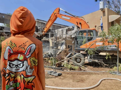 A bulldozer destroys a house that was damaged during the Oct. 7, 2023, massacre in Kibbutz Be'eri, near the Israeli border with the Gaza Strip, July 7, 2024. Photo by Oren Cohen/Flash90.