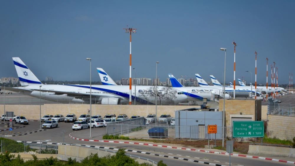 View of the empty parking lot and planes in the background at Ben-Gurion International Airport on March 10, 2020. Photo by Avshalom Sassoni/Flash90.