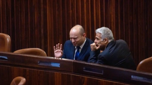 Yamina Party leader Naftali Bennett (left) and Yesh Atid Party head Yair Lapid in the Knesset plenum hall during the voting in the presidential elections, June 2, 2021. Photo by Olivier Fitoussi/Flash90.