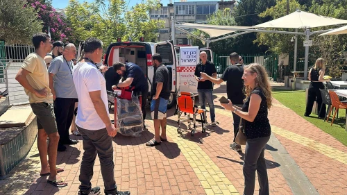 Students gather in front of a Magen David Adom ambulance during the Afeka College of Engineering hackathon which was held in cooperation with the life-saving emergency organization. Credit: Courtesy.