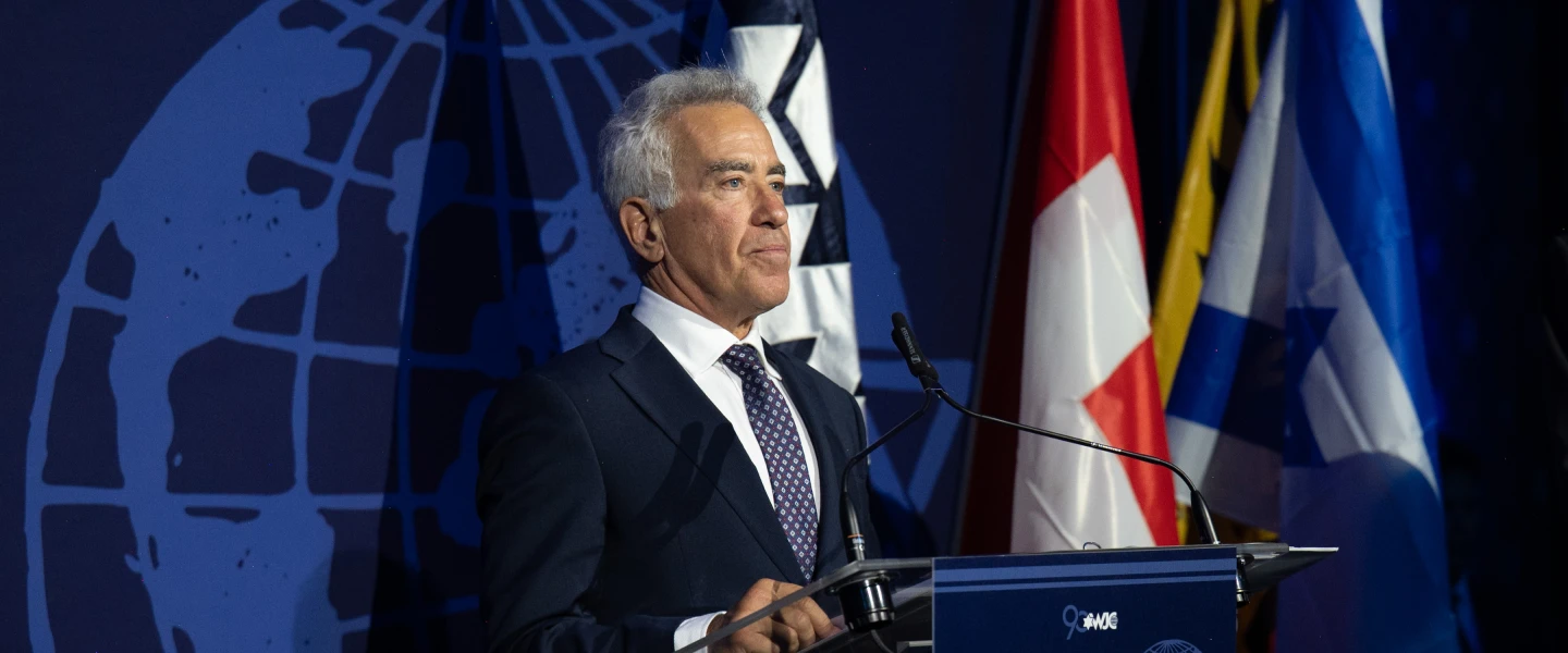 Sylvan Adams, president of the World Jewish Congress Israel Region, speaks about the family of Ran Gvili during the WJC 90th anniversary gala in Geneva, saying Gvili’s memory “is now forever part of the story of Jewish courage and resilience,” May 11, 2026. Photo by Shahar Azran/WJC.