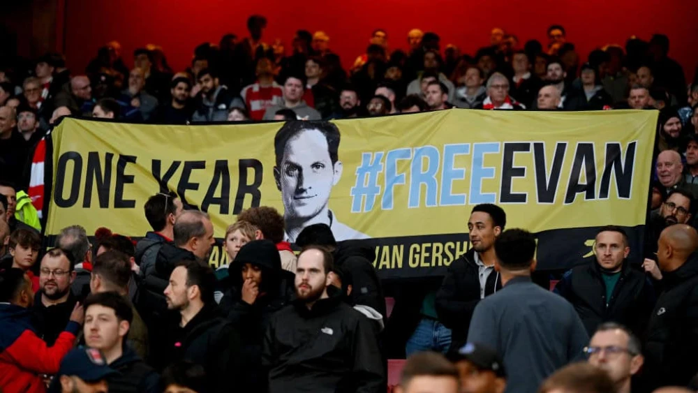 Fans display a banner in support of Evan Gershkovich, an American journalist imprisoned in Russia, during a Premier League match at Emirates Stadium in London, England on April 3, 2024. Credit: Shaun Botterill / Getty Images.