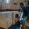 Shelly Sarah, a 22 year old Israeli from Hadera, stops at the Western Wall stone on display at Israel's Ben-Gurion International airport before a trip to Thailand as her boyfriend looks on, March 25, 2025. Credit: Rina Castelnuovo.