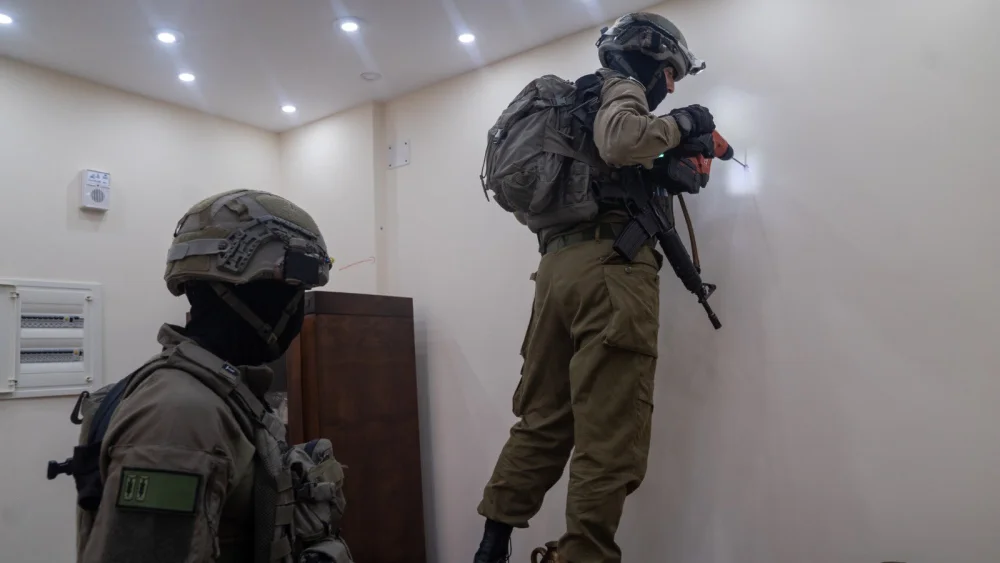 Israeli soldiers map the home in Nablus of Muad Masri, one of the Hamas terrorists who murdered three members of the Dee family, June 13, 2023. Credit: IDF.