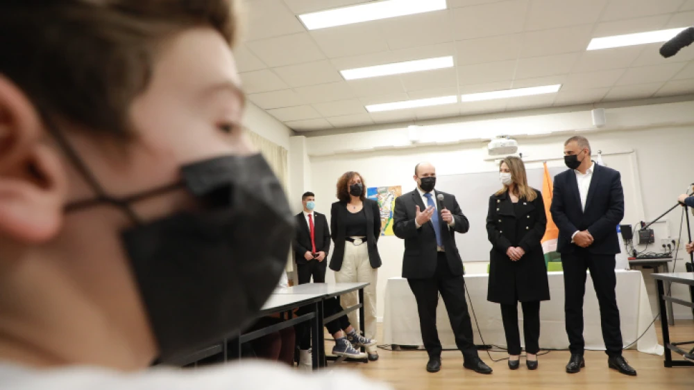 Israeli Prime Minister Naftali Bennett and Education Minister Yifat Shasha Biton visit students at a school in Kfar Saba, Feb. 9, 2022. Photo by Dana Kopel/POOL.