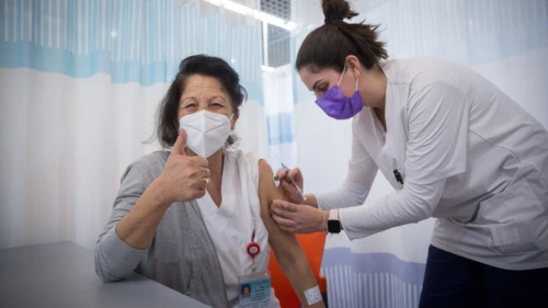 A staff member receives a second dose of Pfizer's BioNTech COVID-19 vaccine at the Sheba Medical Center at Tel HaShomer on Jan. 10, 2021. Photo by Miriam Alster/Flash90.