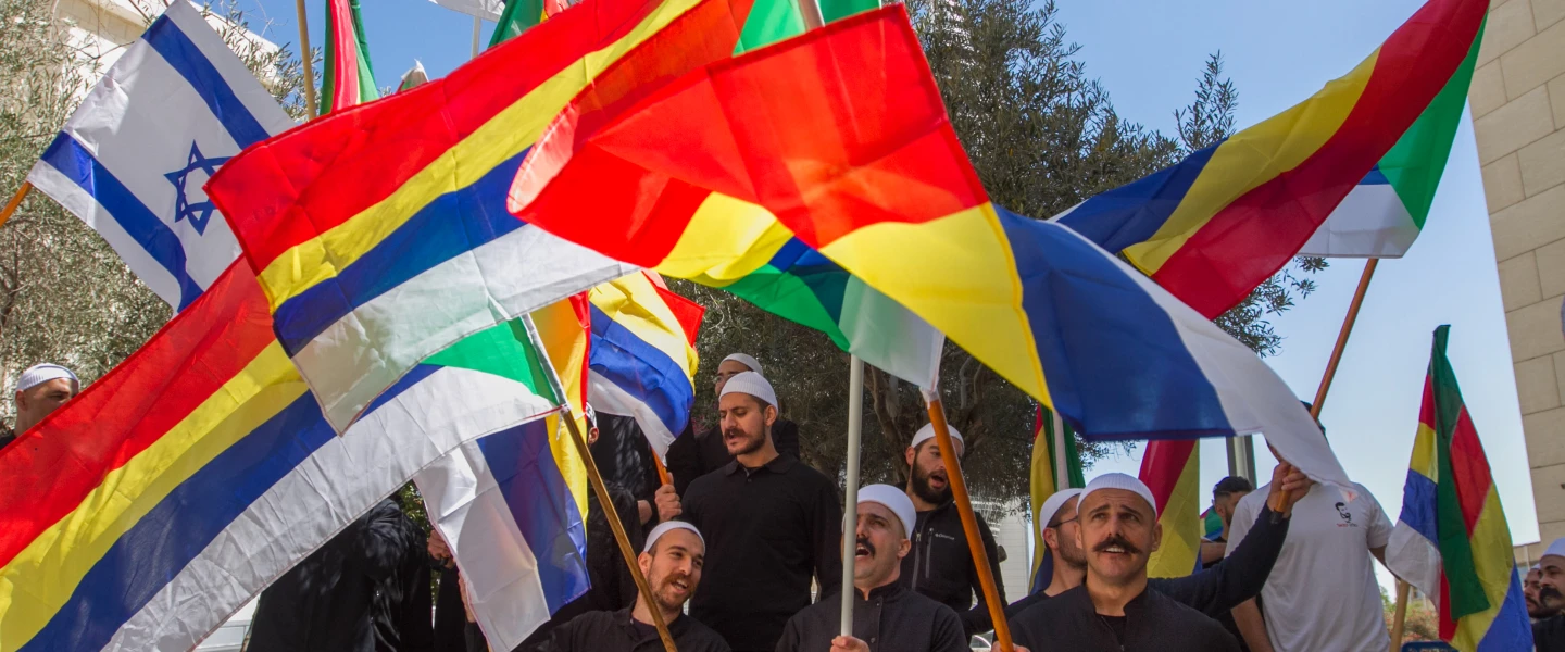 Druze men protest outside the Hafia District Court, carrying both the Druze and the Israeli flags. Photo by Flash90.