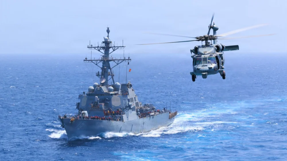USS Donald Cook (DDG 75) transits the Arabian Sea while an MH-60S Sea Hawk flies nearby. Credit: United States Central Command.