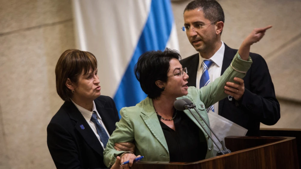 Knesset member Hanin Zoabi is removed by Knesset security during her speech at a plenum session before a vote on a bill requiring left-wing foundations and organizations to reveal their sources of funding, on Feb. 8, 2016. Photo by Hadas Parush/Flash90.