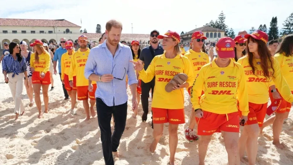 Britain's Prince Harry and his wife, Meghan Markle, with volunteer first responders at Bondi Beach in Sydney, April 17, 2026. Photo by Jonathan Brady/POOL/AFP.