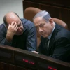 Israeli Prime Minister Benjamin Netanyahu speaks with Defense Minister Moshe Ya'alon in the plenary hall of the Knesset, the Israeli parliament in Jerusalem, May 11, 2015. Photo by Miriam Alster/Flash90.