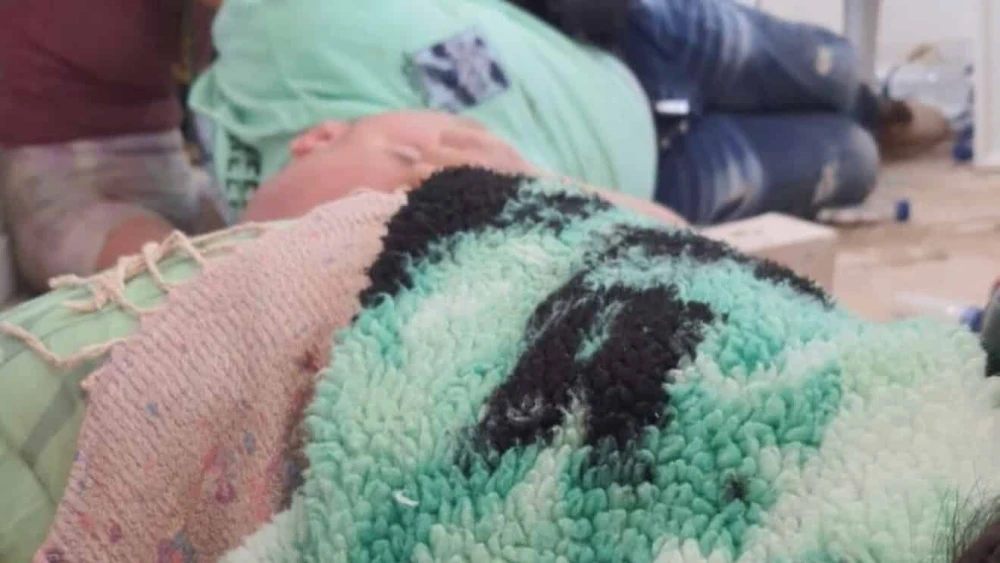 Rita (with braids) and Guy (in the green T-shirt) hiding at the ticket booth in Re’im on Oct. 7, 2023. Photo by Rita Shtivelman.