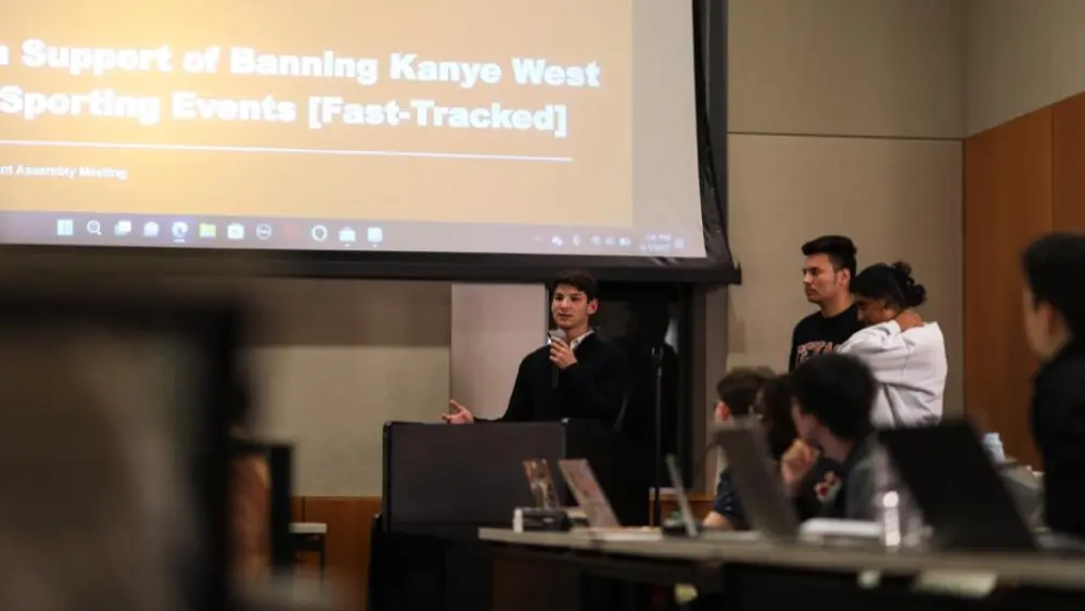 Student representative Alexander Feinstein speaks before a vote on a resolution to ban the music of Kanye West at sporting events on the University of Texas at Austin. Credit: Courtesy of Alexander Feinstein