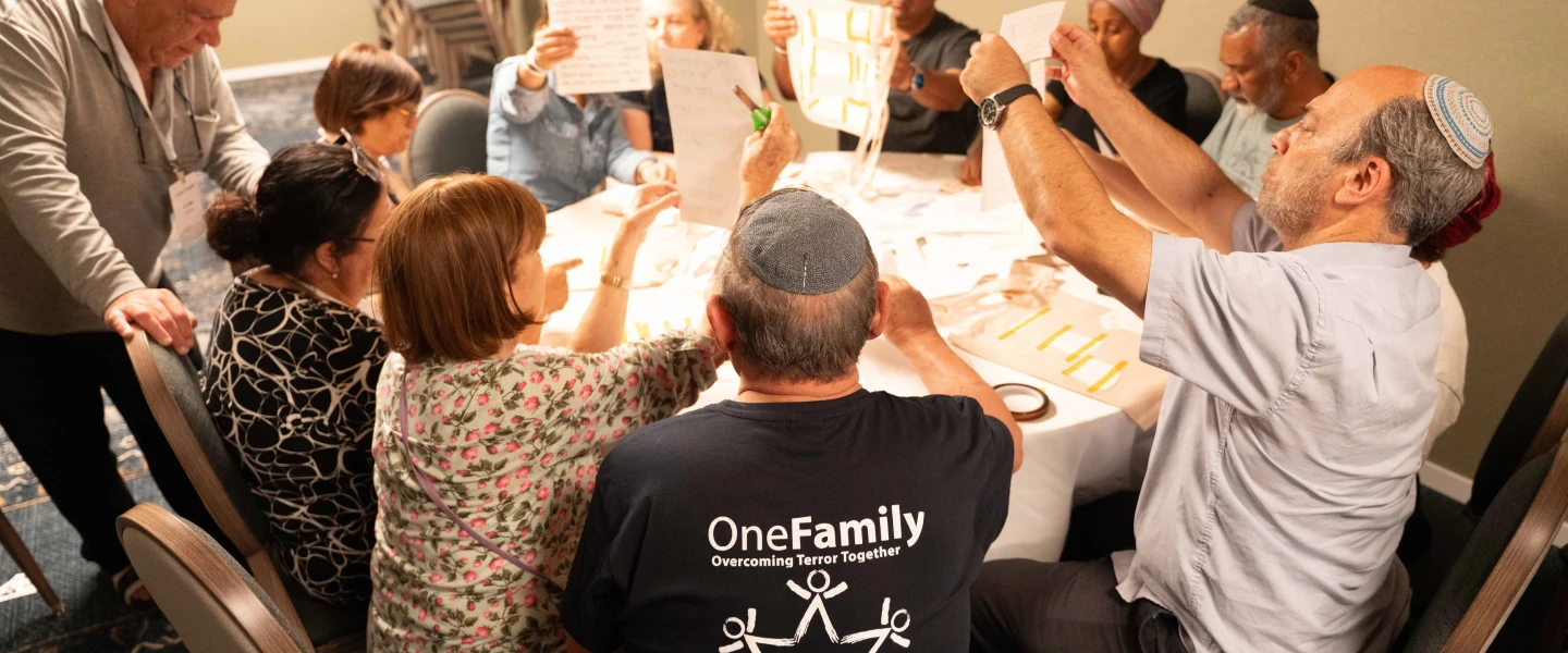 Bereaved families comfort one another at OneFamily's pre-Memorial Day retreat at the Kinneret. Photo by Meir Pavlovsky.