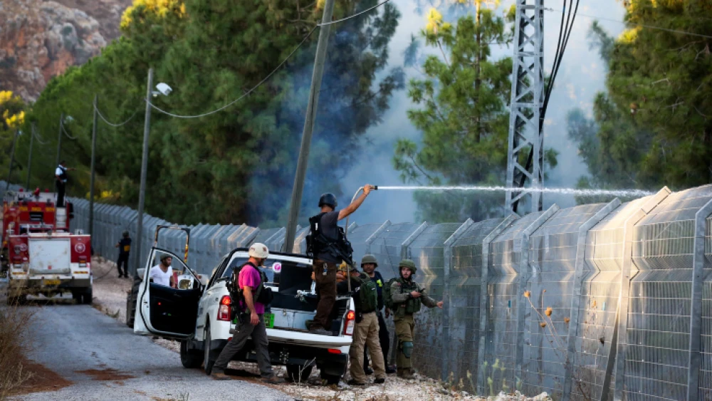 Israeli security forces try to extinguish a fire caused by a Hezbollah rocket launched from Lebanon near Moshav Avivim in the Galilee panhandle, Sept. 1, 2019. Photo by David Cohen/Flash90.