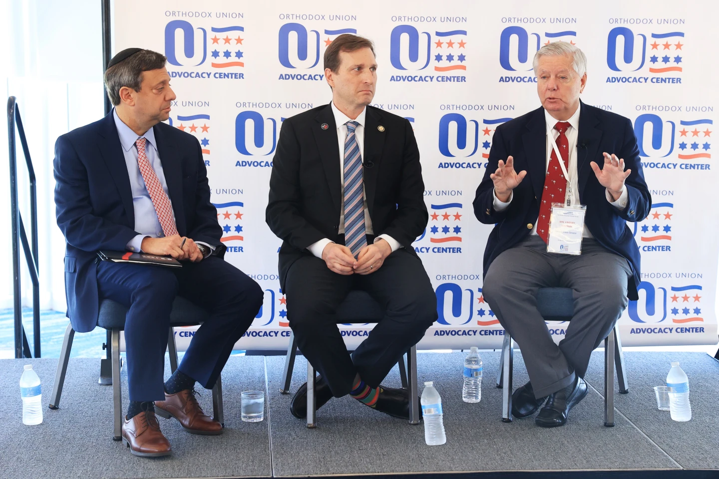 Sen. Lindsey Graham (R-S.C.) speaks at an Orthodox Union Advocacy Center event in 2025 in Fort Lauderdale, Fla., as Rep. Dan Goldman (D-N.Y) and OU Advocacy executive director Nathan Diament look on. Credit: OU Advocacy Center.