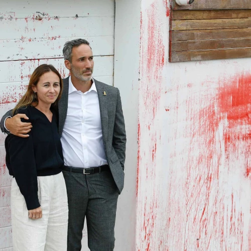 Alex and Vicki Ryvchin stand outside their vandalized former home in Sydney in January. Credit: Courtesy of Alex Ryvchin.